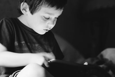 Boy holding digital tablet at home