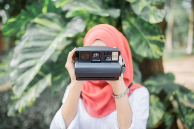 Rear view of woman photographing
