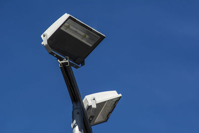 Low angle view of street light against clear blue sky