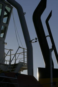 Low angle view of silhouette bridge against sky at dusk