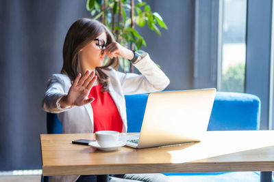 Young woman using laptop on table