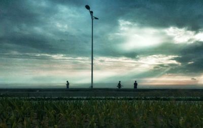 Scenic view of field against cloudy sky