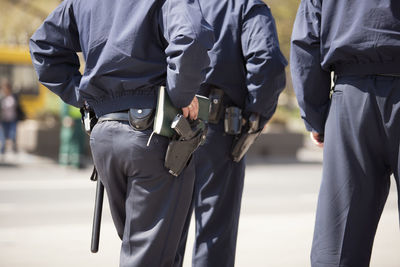 Rear midsection of police force on street