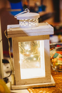 Close-up of electric lamp on table