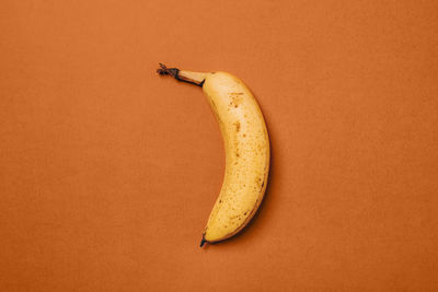 Close-up of bananas against orange background