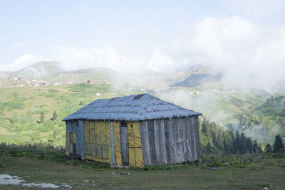 Built structure on field against sky