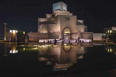 Illuminated building in city at night