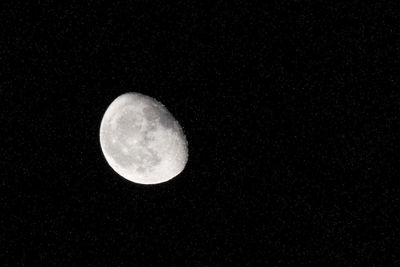 Low angle view of moon against clear sky at night