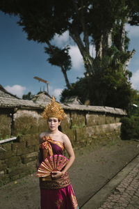 Portrait of woman wearing traditional clothing standing outdoors