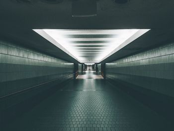 Empty subway along tiled wall