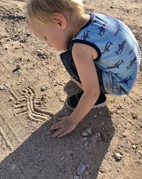 High angle view of girl on sand at beach