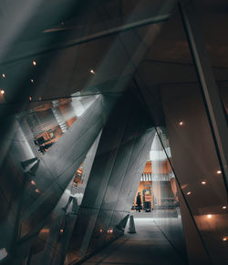 Low angle view of illuminated modern building in city