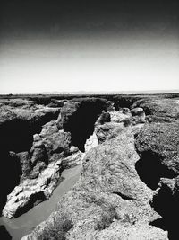 Scenic view of rocks against clear sky