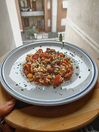 High angle view of person holding food in plate