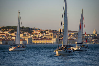 Sailboat sailing in sea against clear sky