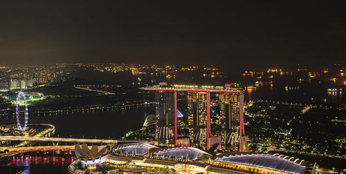 High angle view of illuminated city buildings at night