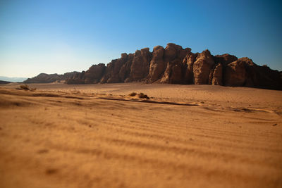 Surface level of desert against sky