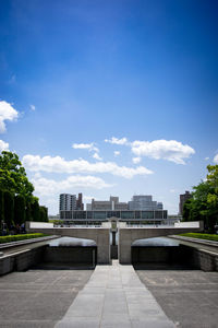 View of city buildings against cloudy sky