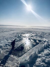 Scenic view of frozen lake against sky during winter