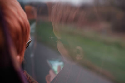 Rear view of woman looking at camera