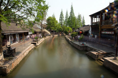 Canal amidst buildings and trees