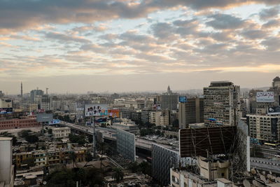 Cityscape against cloudy sky