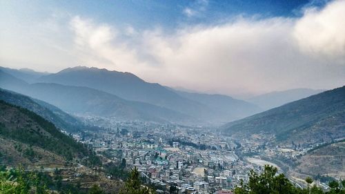 Scenic view of mountains against cloudy sky