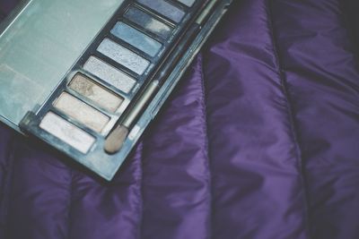 High angle view of eyeshadow on bed