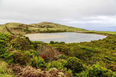  panoramic view of lake and mountains against the sky.