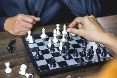 People playing chess on table