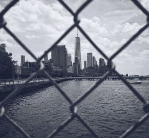 View of city through chainlink fence