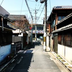 Street amidst buildings in city against sky