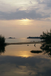 Scenic view of sea against cloudy sky