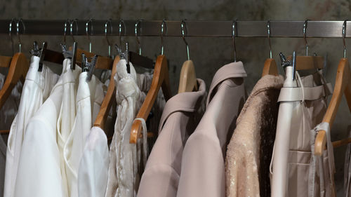 A hanger with clothes in a boutique or showroom. beige trend of  season
