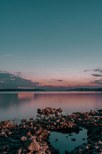 Scenic view of lake against sky during sunset