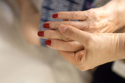 Close-up of women holding hands