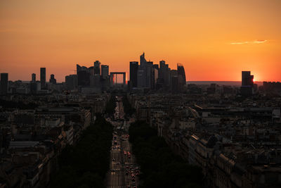 Aerial view of buildings in city during sunset