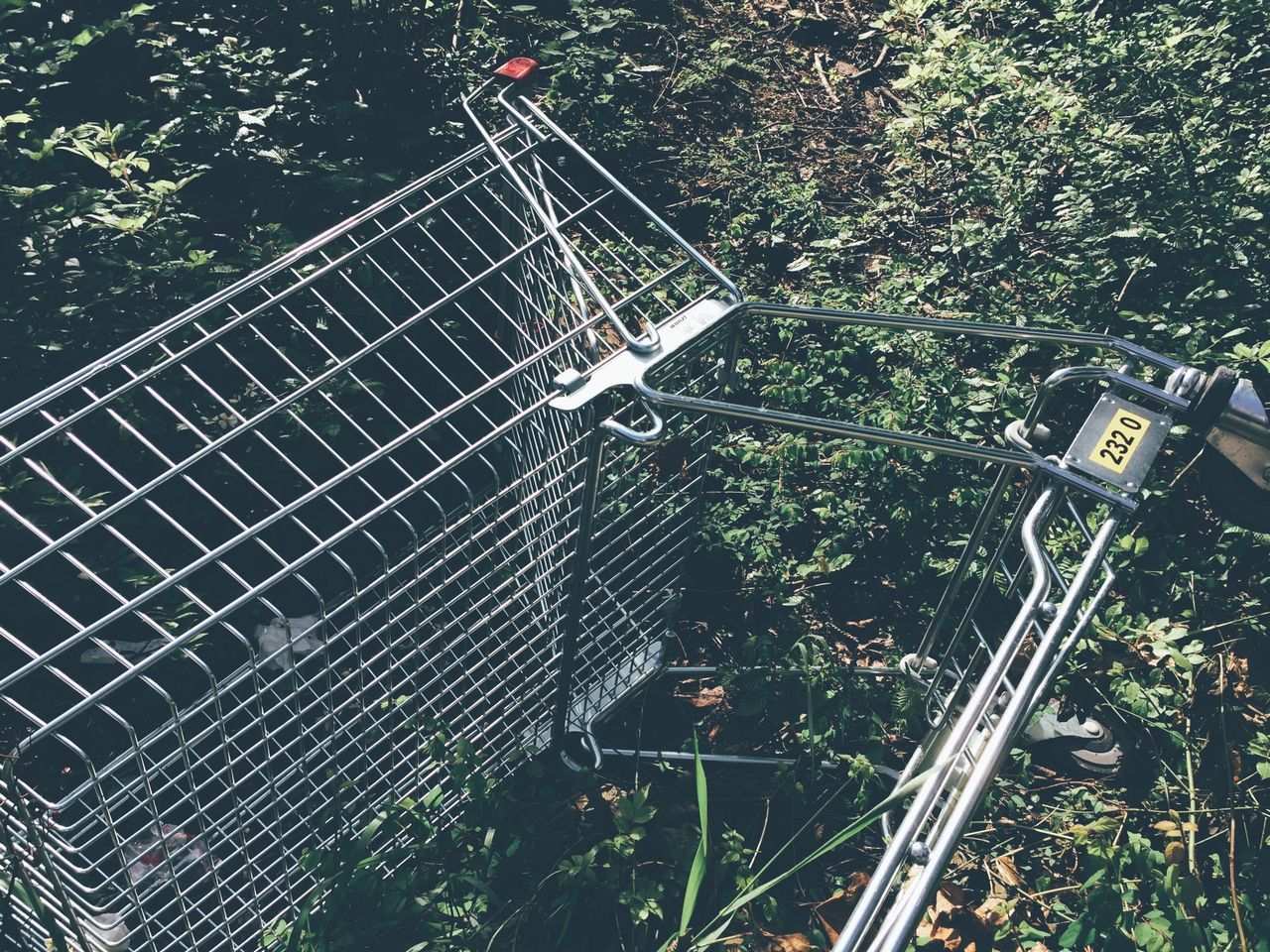 metal, plant, metallic, high angle view, growth, tree, no people, day, outdoors, low angle view, fence, communication, protection, chainlink fence, safety, nature, text, green color, security, transportation