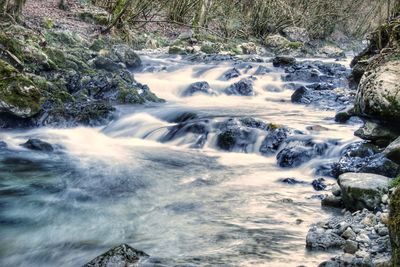 View of river flowing through rocks