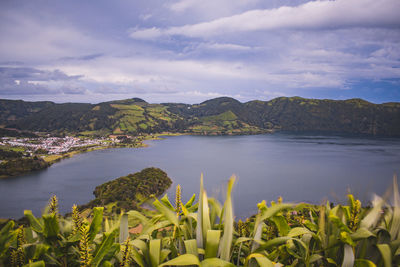 Scenic view of lake and mountains against sky