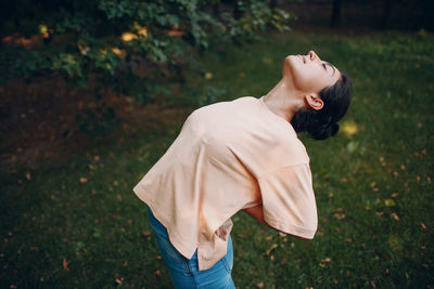 Rear view of woman standing on field