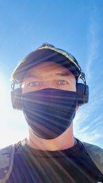 Portrait of young man against blue sky