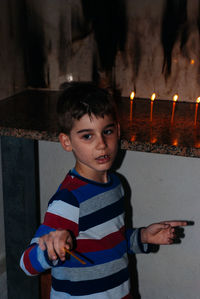 Cute boy holding incense at church