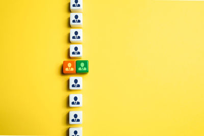 Directly above shot of toy blocks on yellow background