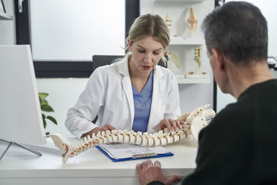 Doctor examining patient in office