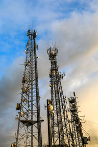 Low angle view of communications tower against sky