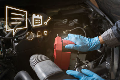 Cropped hand of man repairing car