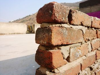 Close-up of stack on rock against wall