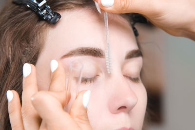 Close-up of woman applying nail