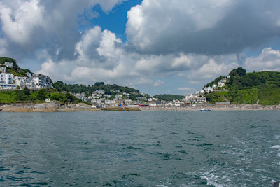 Scenic view of sea by city against sky